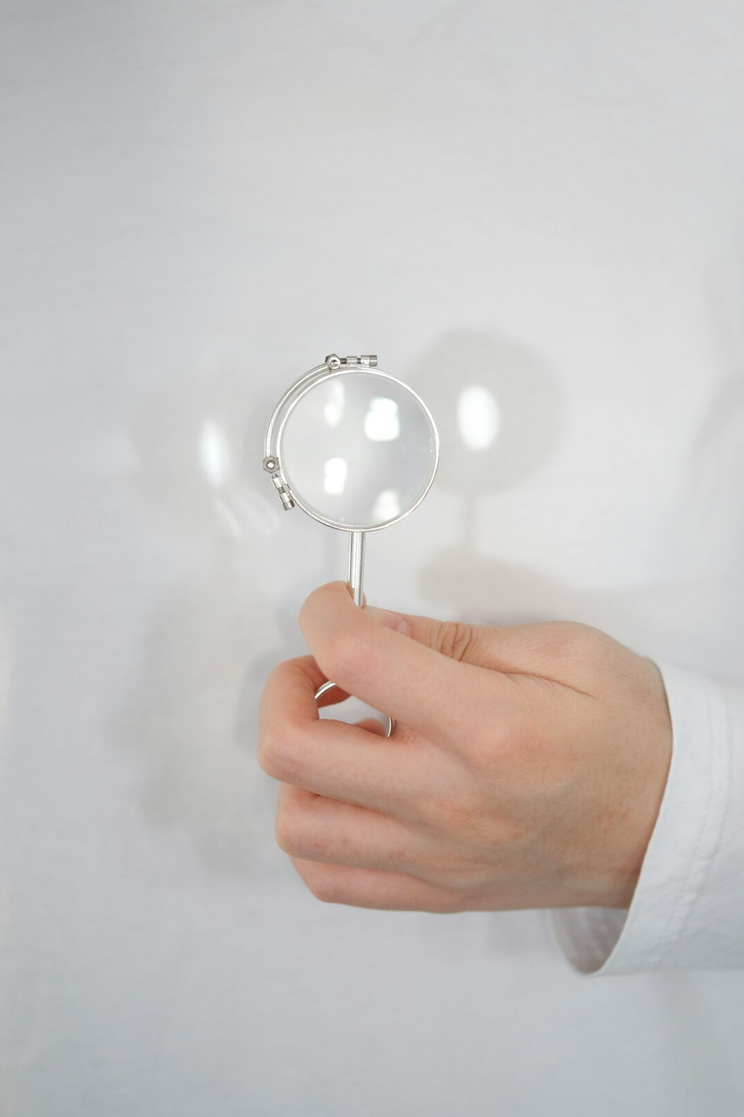 person holding magnifying glass